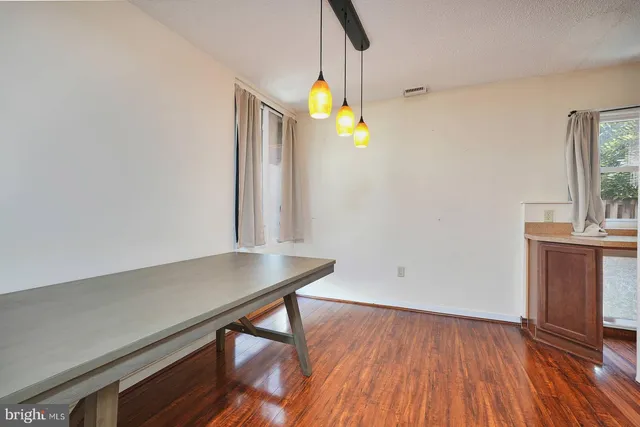 a view of a room with wooden floor and windows