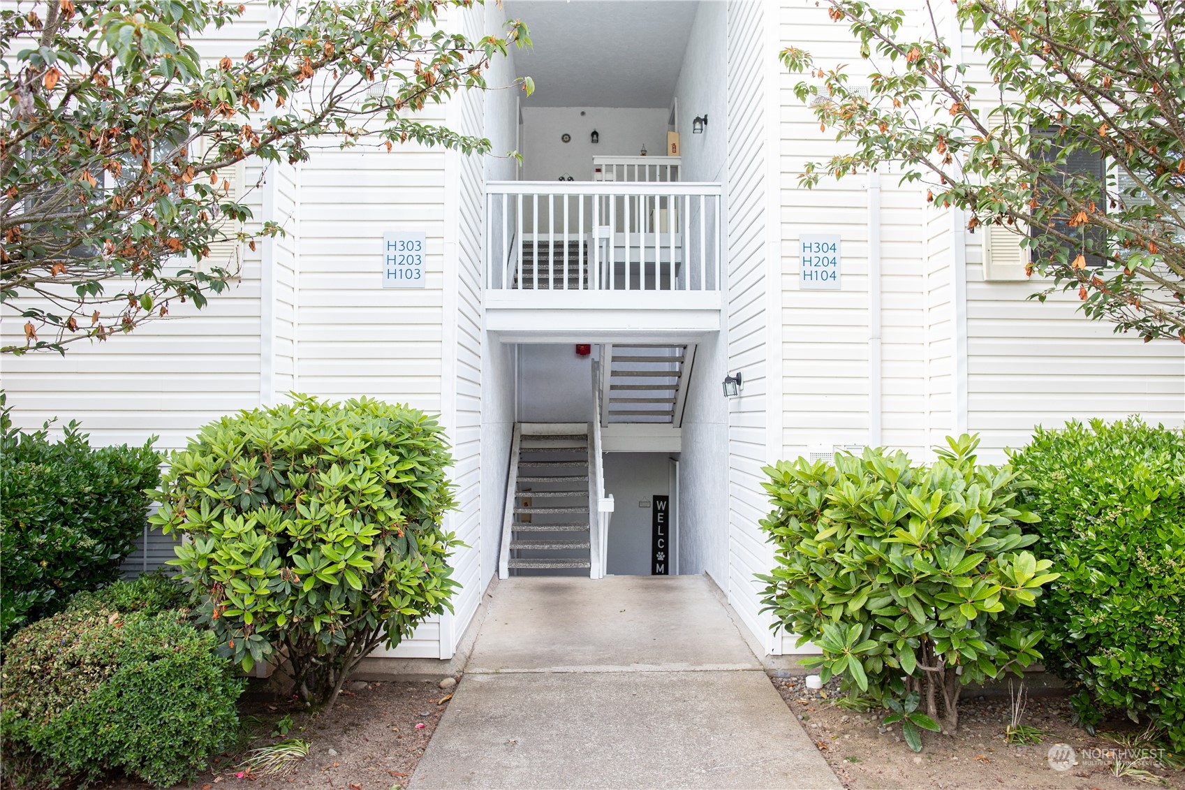11002 Southeast Petrovitsky Road, Unit H103 Renton, WA 98055 - Photo 1 of 20 a front view of a house with garden