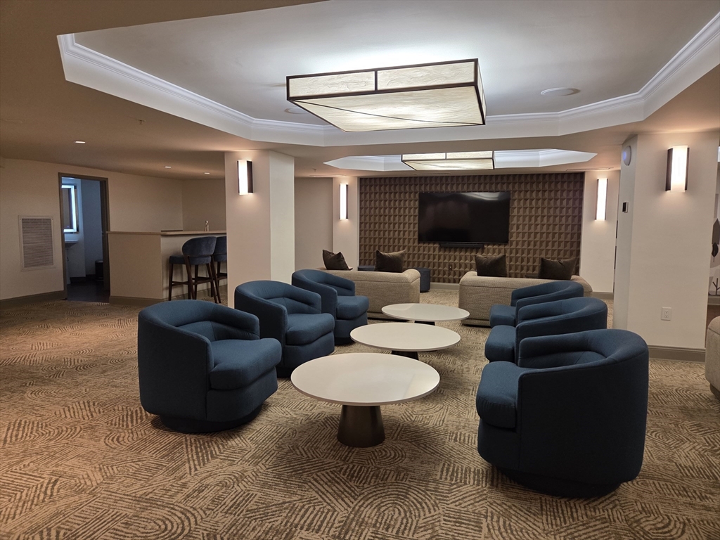 20 Chapel Street, Unit B811 Brookline, MA 02446 - Photo 32 of 41 a living room with furniture and a large window