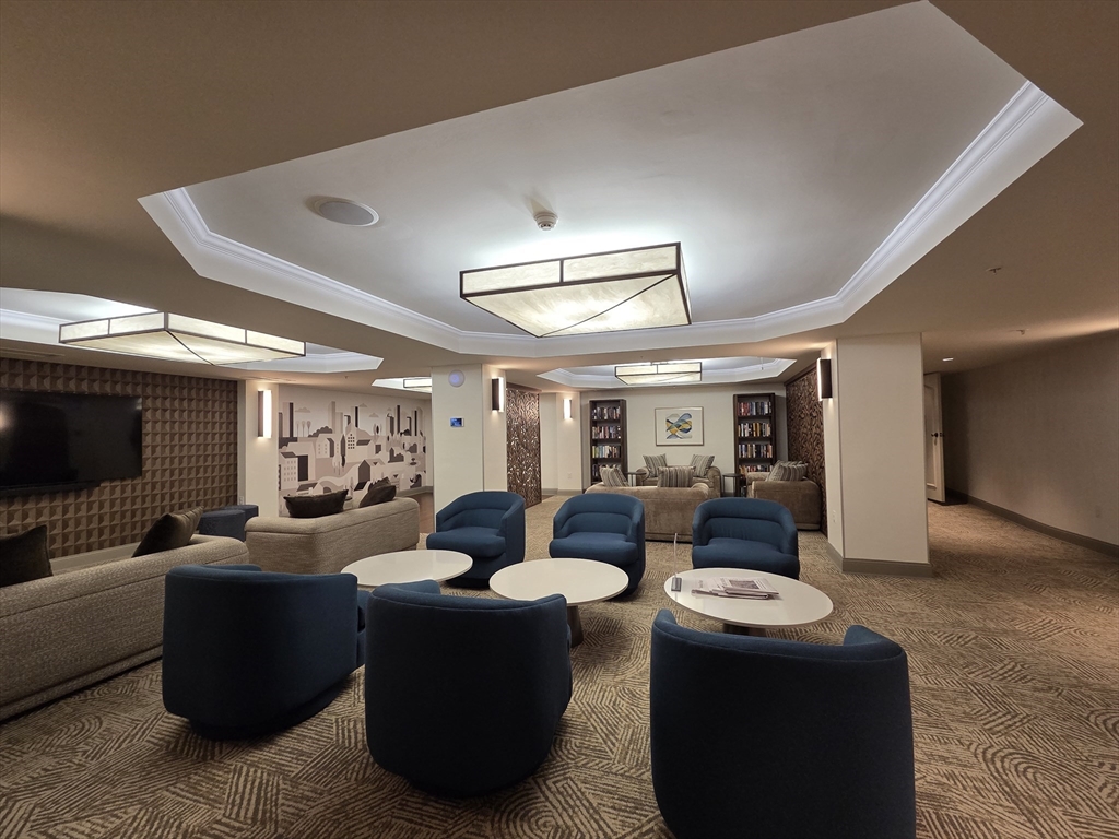 20 Chapel Street, Unit B811 Brookline, MA 02446 - Photo 34 of 41 a living room with furniture and a flat screen tv