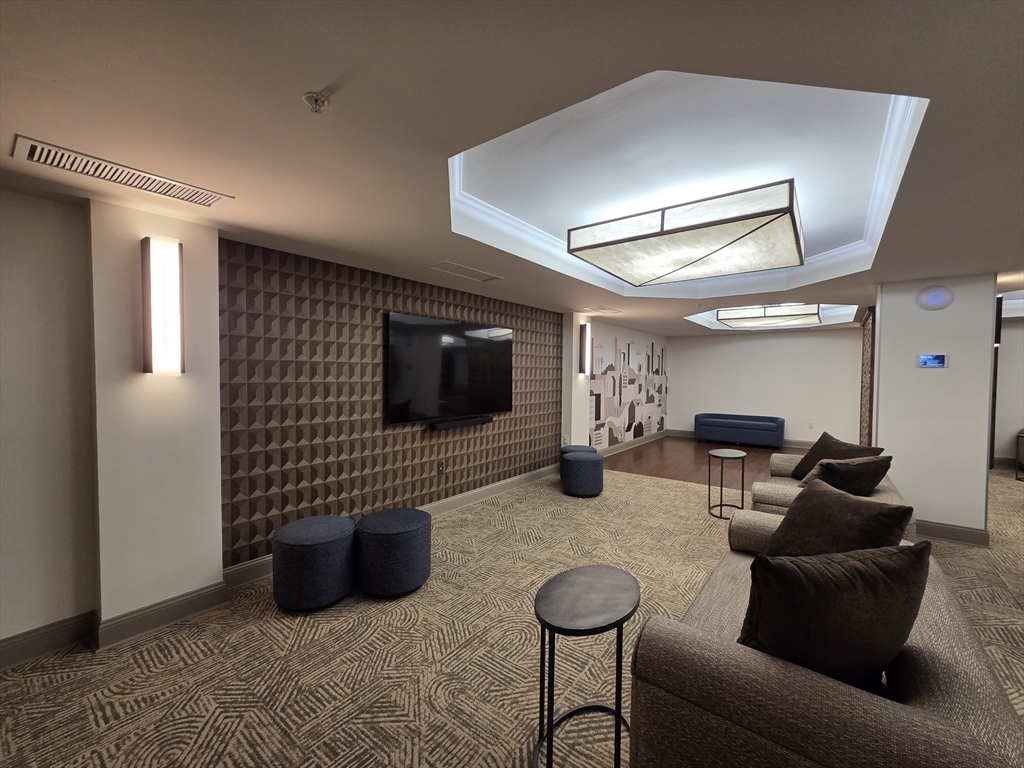 20 Chapel Street, Unit B811 Brookline, MA 02446 - Photo 35 of 41 a living room with furniture and a flat screen tv