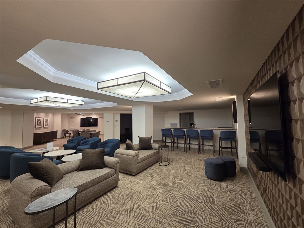 20 Chapel Street, Unit B811 Brookline, MA 02446 - Photo 37 of 41 a living room with furniture and a large window