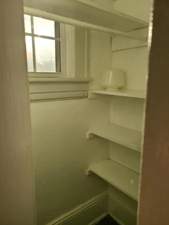 a view of storage and utility room with cabinet