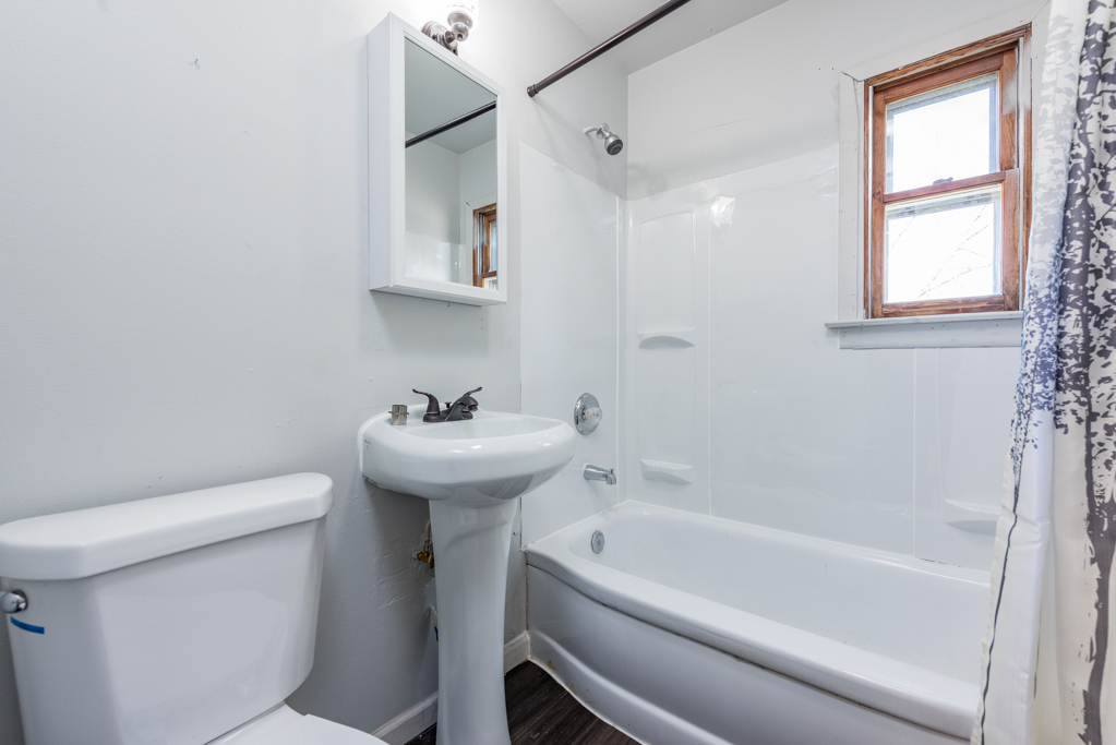 1636 Rice Street Waukegan, IL 60087 - Photo 18 of 26 a bathroom with a sink a toilet and bathtub