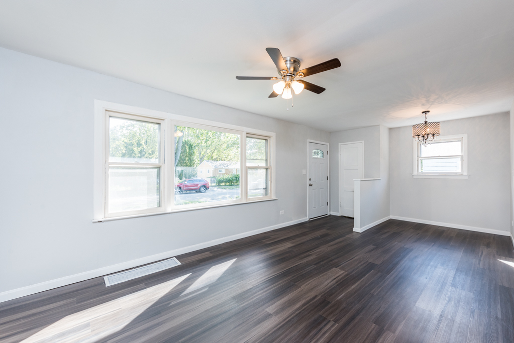 1636 Rice Street Waukegan, IL 60087 - Photo 6 of 26 a view of empty room with wooden floor and fan