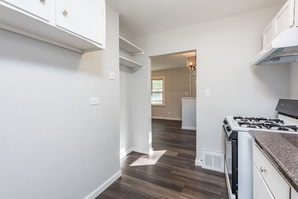 1636 Rice Street Waukegan, IL 60087 - Photo 9 of 26 a kitchen with a stove and wooden floor