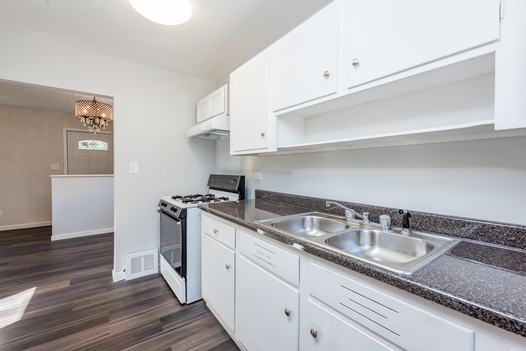 1636 Rice Street Waukegan, IL 60087 - Photo 10 of 26 a kitchen with granite countertop a sink and a stove
