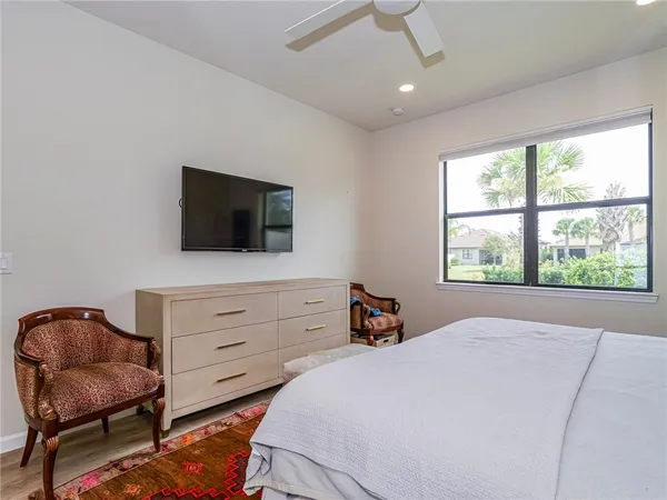 a bedroom with a bed and furniture with mirror