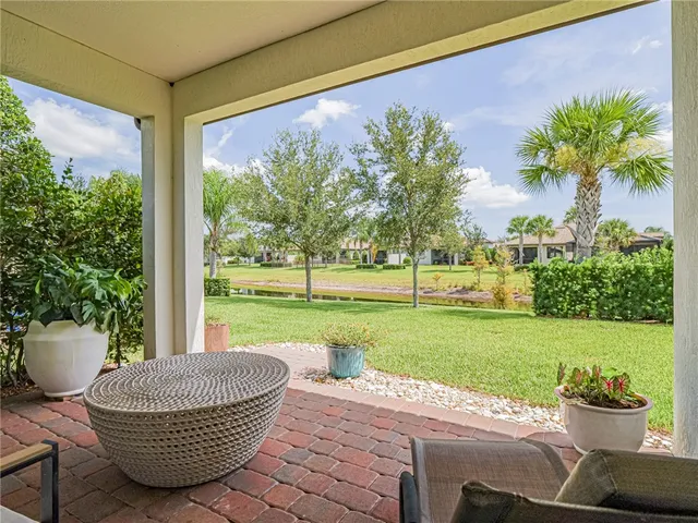 a view of a porch with furniture and garden