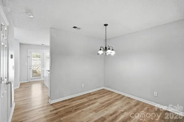 a kitchen with stainless steel appliances a sink a stove a refrigerator and cabinets