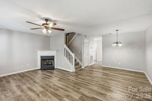 a view of a room with wooden floor and ceiling fan