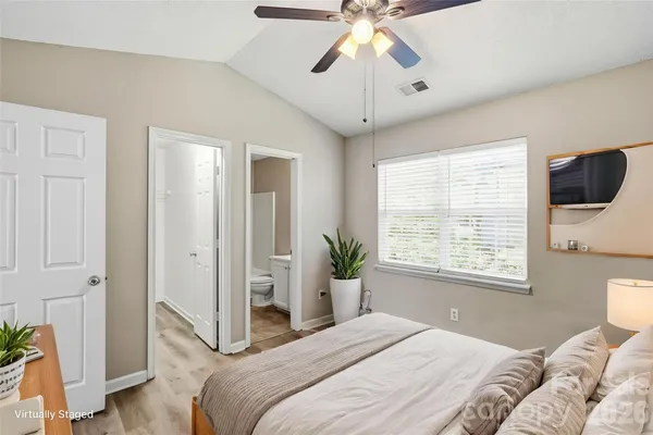 a bedroom with bed and a window