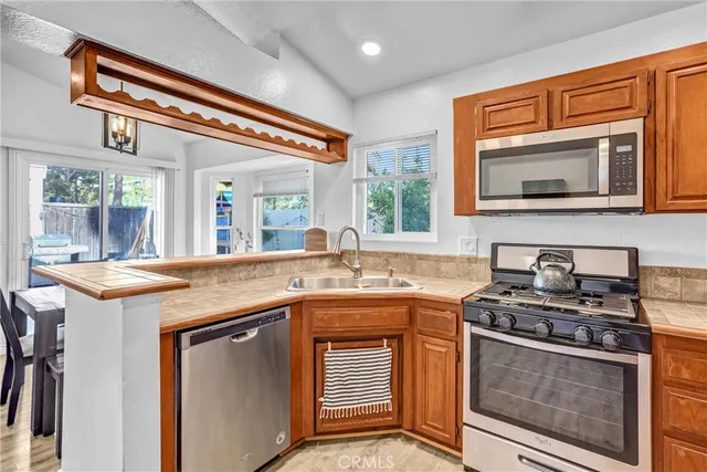 a kitchen with stainless steel appliances granite countertop stove a sink and a microwave