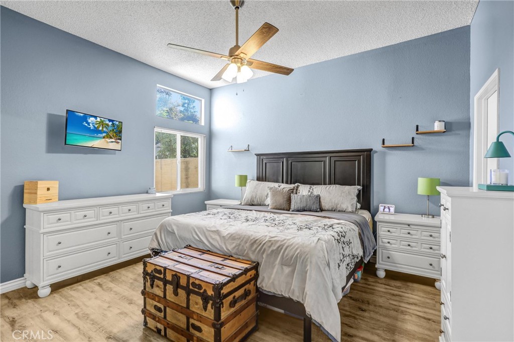 14519 El Contento Avenue Fontana, CA 92337 - Photo 13 of 30 a bedroom with a bed and a chandelier