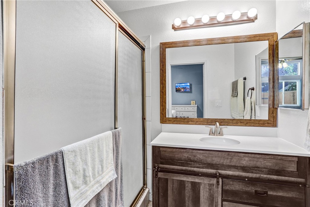 14519 El Contento Avenue Fontana, CA 92337 - Photo 16 of 30 a bathroom with a sink and a mirror