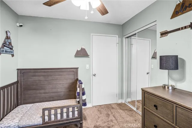 a bedroom with a bed and a desk