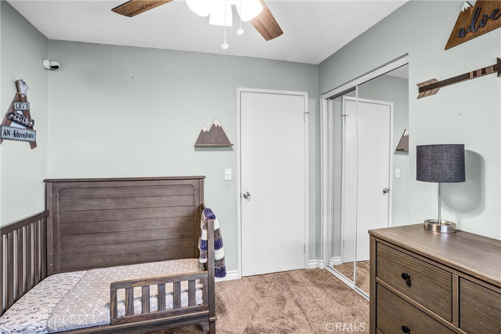 14519 El Contento Avenue Fontana, CA 92337 - Photo 18 of 30 a bedroom with a bed and a desk