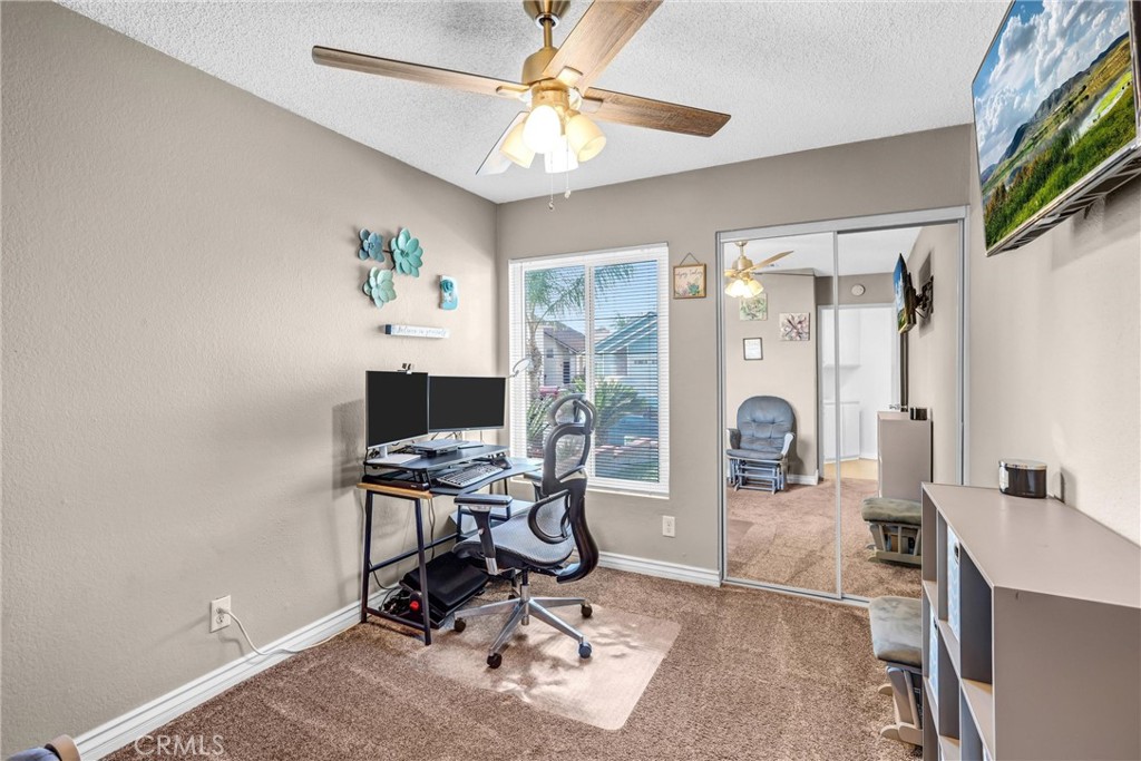 14519 El Contento Avenue Fontana, CA 92337 - Photo 19 of 30 a view of a workspace with furniture and a window
