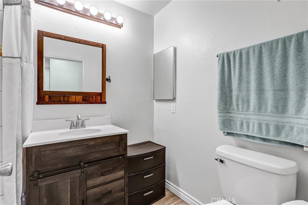 14519 El Contento Avenue Fontana, CA 92337 - Photo 21 of 30 a bathroom with a sink a toilet and mirror