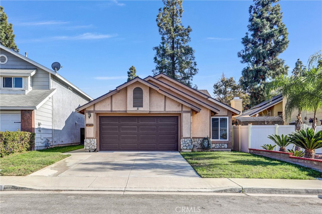14519 El Contento Avenue Fontana, CA 92337 - Photo 30 of 30 a front view of a house with a garden