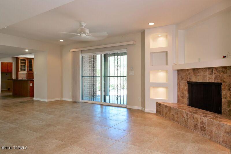 8001 East Presidio Road Tucson, AZ 85750 - Photo 10 of 25 a view of an empty room with a fireplace and a window