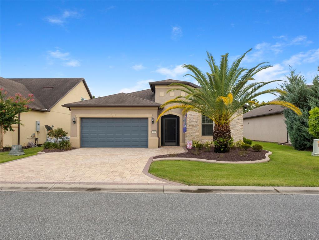 7807 Southwest 97th Circle Ocala, FL 34481 - Photo 3 of 50 a front view of a house with a yard and garage