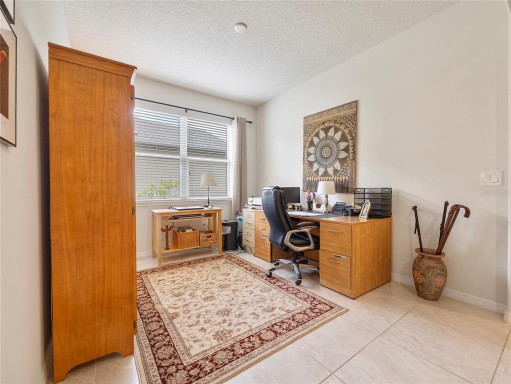 7807 Southwest 97th Circle Ocala, FL 34481 - Photo 31 of 50 a view of a workspace with furniture and a window