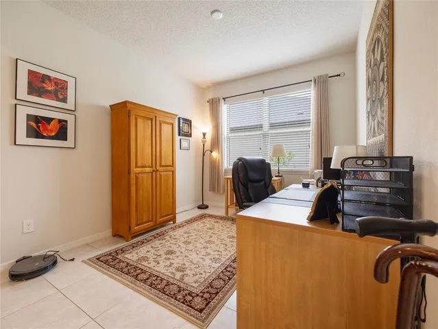 a bedroom with a bed and a refrigerator