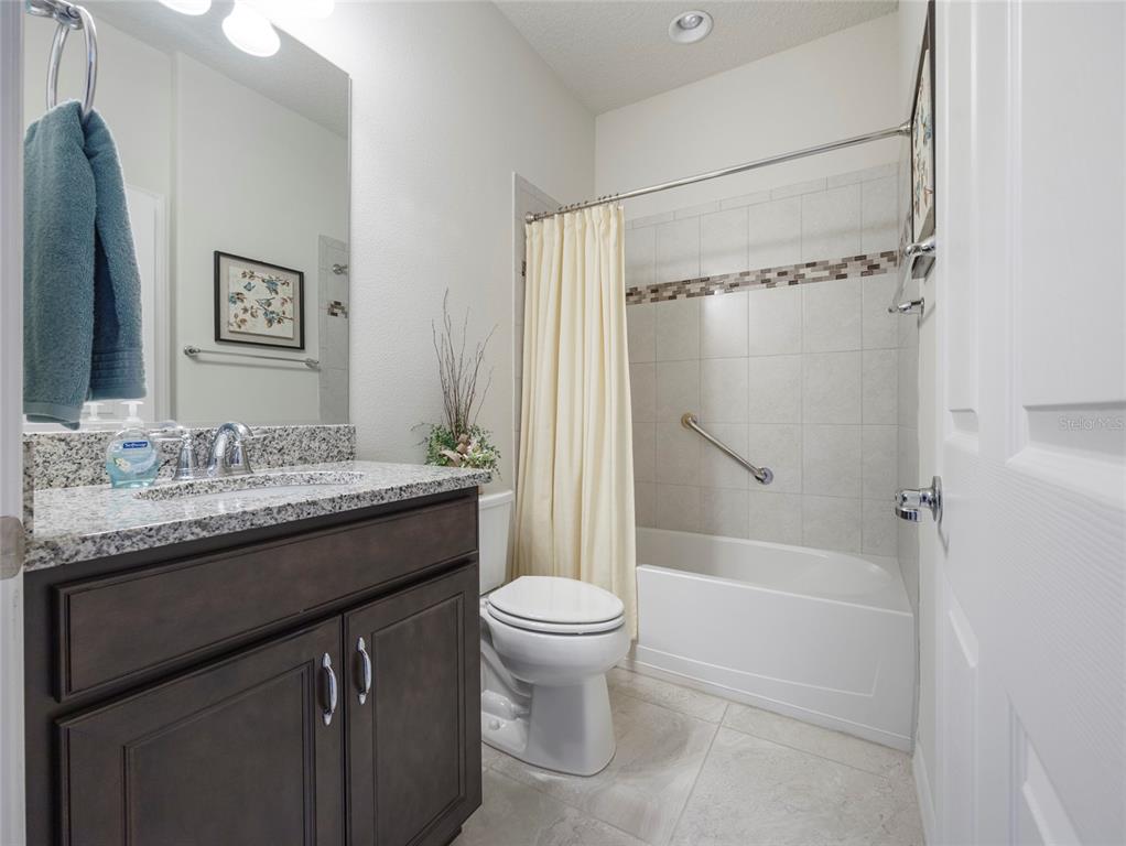 7807 Southwest 97th Circle Ocala, FL 34481 - Photo 36 of 50 a bathroom with a granite countertop sink toilet and shower