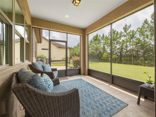 a living room with furniture and a floor to ceiling window