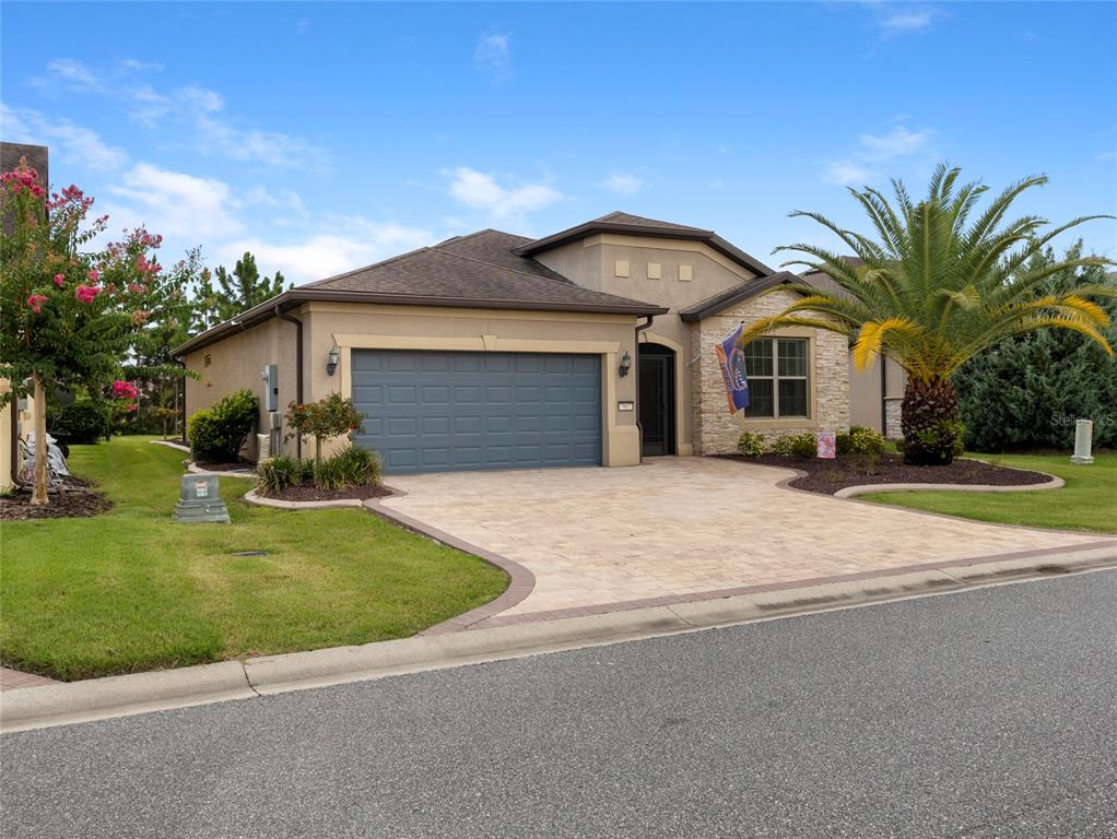 7807 Southwest 97th Circle Ocala, FL 34481 - Photo 4 of 50 a front view of a house with garden and trees