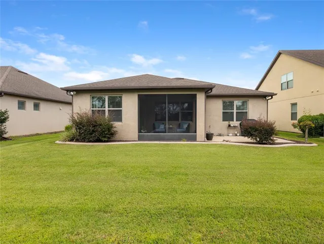 a front view of house with yard and outdoor seating