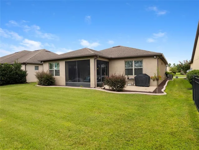 a view of a house with a backyard and porch