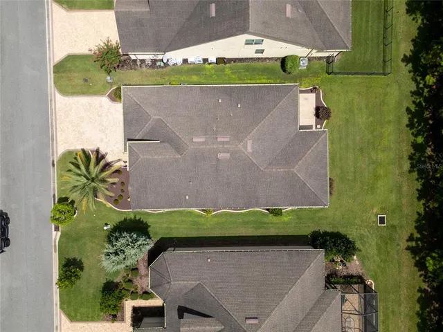an aerial view of a house with a garden and a yard