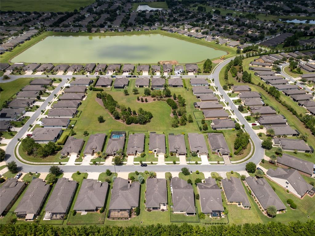 7807 Southwest 97th Circle Ocala, FL 34481 - Photo 48 of 50 an aerial view of a house with a garden and lake view