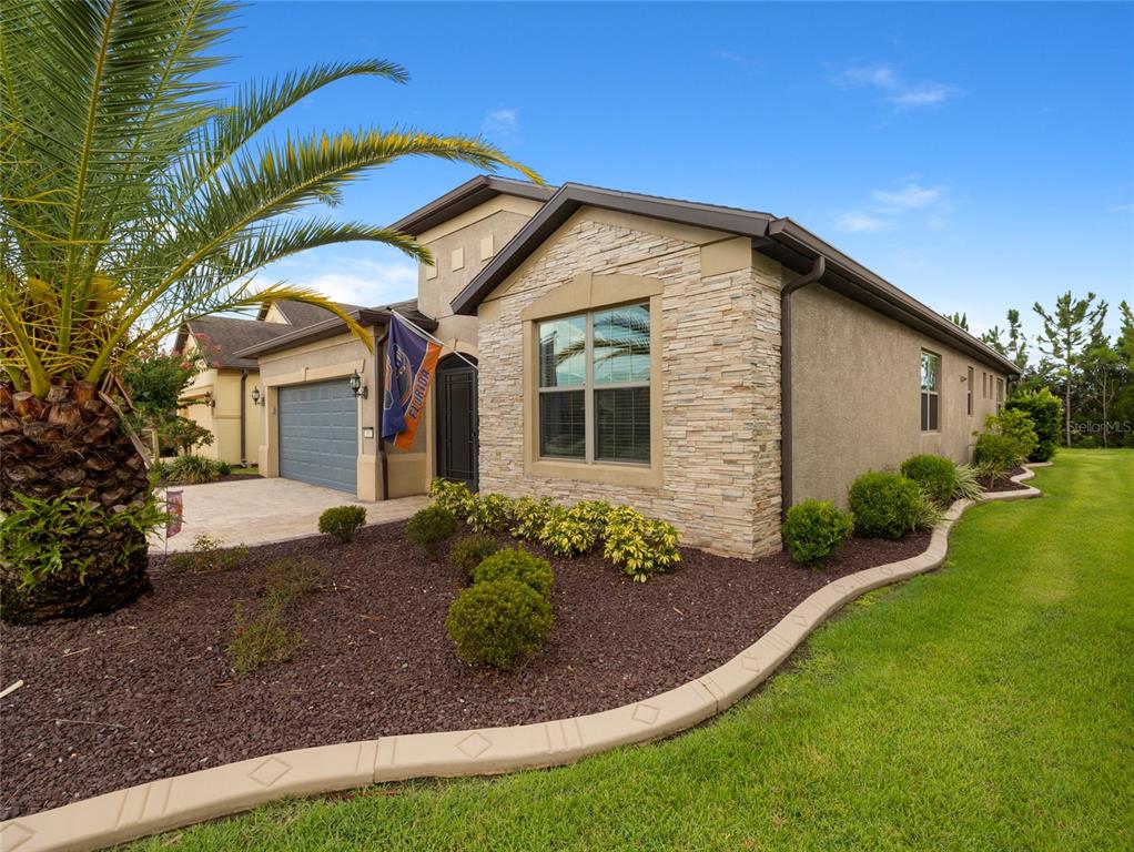 7807 Southwest 97th Circle Ocala, FL 34481 - Photo 5 of 50 a front view of a house with a garden