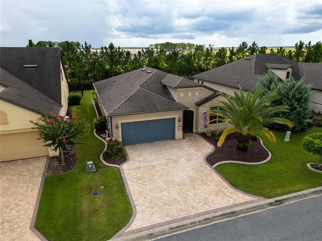 a view of a house with a yard and sitting area