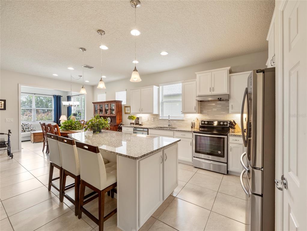 7807 Southwest 97th Circle Ocala, FL 34481 - Photo 10 of 50 a kitchen with a sink stainless steel appliances and white cabinets
