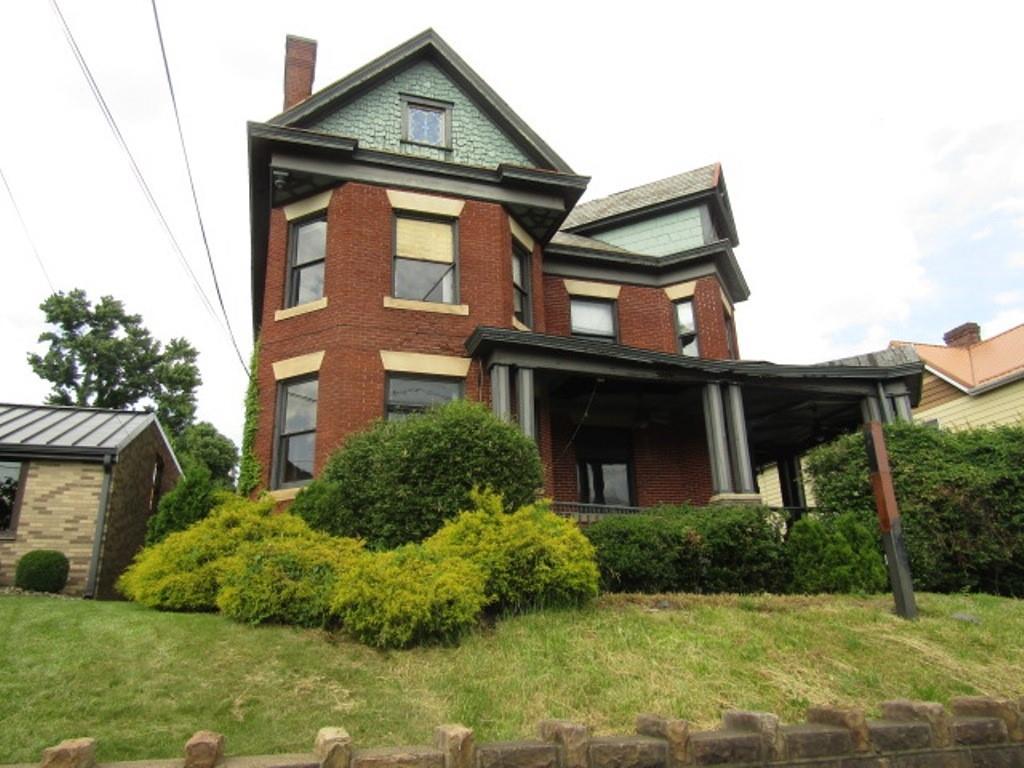 246 West Main Street Uniontown, PA 15401 - Photo 2 of 42 a front view of a house with a yard