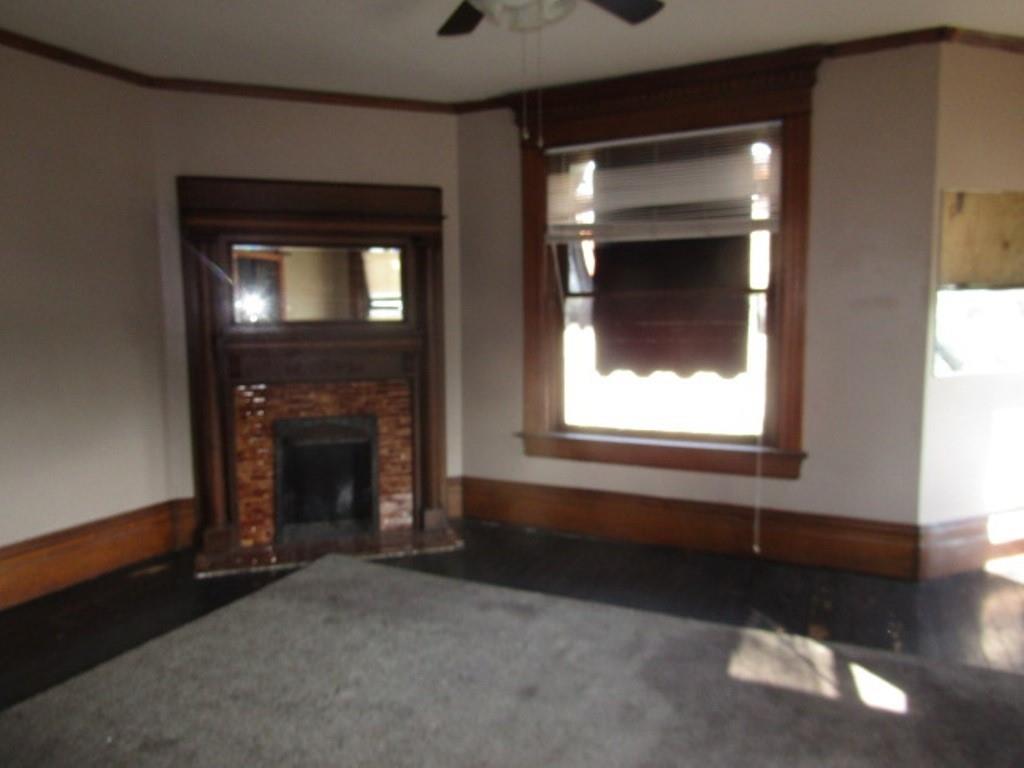 246 West Main Street Uniontown, PA 15401 - Photo 25 of 42 a view of an empty room with a fireplace and a window