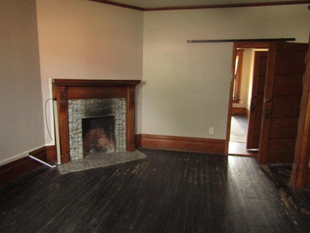 246 West Main Street Uniontown, PA 15401 - Photo 29 of 42 a view of an empty room with wooden floor and a fireplace