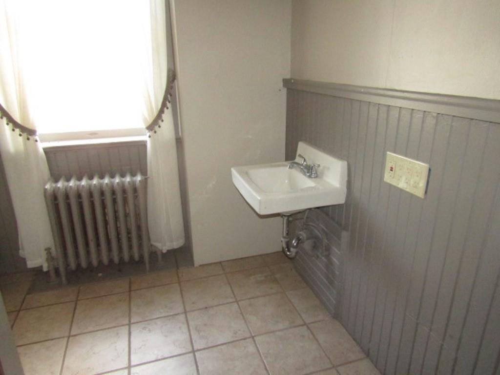 246 West Main Street Uniontown, PA 15401 - Photo 30 of 42 a bathroom with a sink toilet and mirror