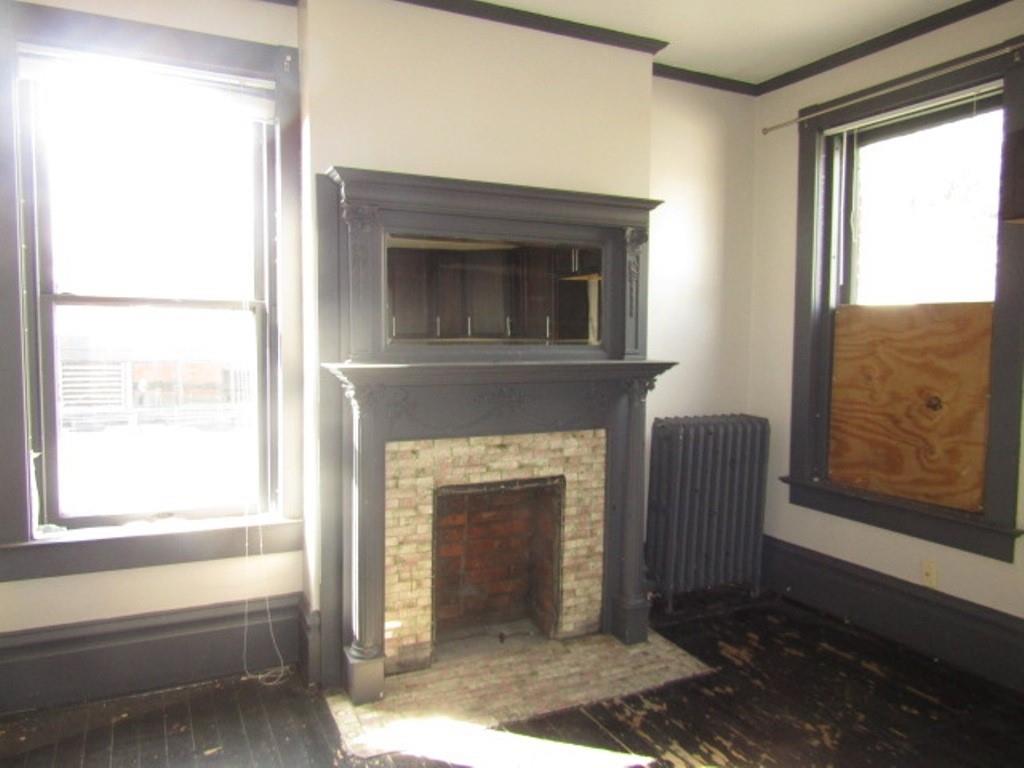 246 West Main Street Uniontown, PA 15401 - Photo 31 of 42 a living room with a fireplace and windows