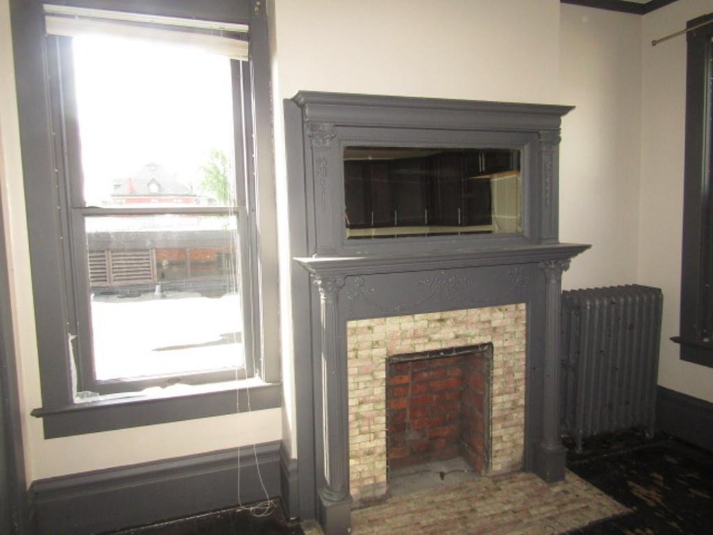 246 West Main Street Uniontown, PA 15401 - Photo 32 of 42 a living room with a fireplace and a window