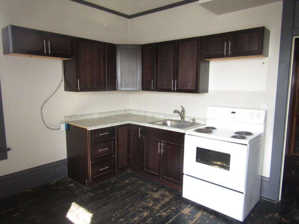 246 West Main Street Uniontown, PA 15401 - Photo 33 of 42 a kitchen with a sink a stove and cabinets