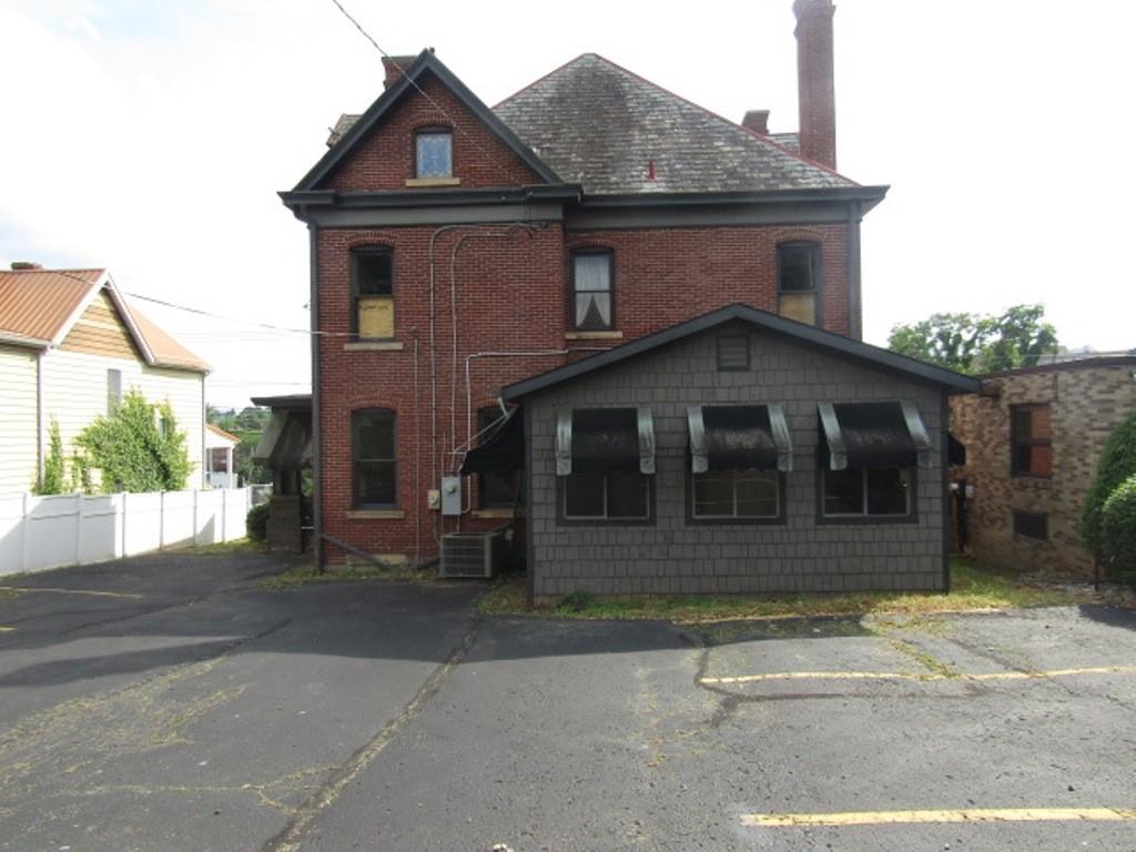 246 West Main Street Uniontown, PA 15401 - Photo 5 of 42 a front view of a house with a yard