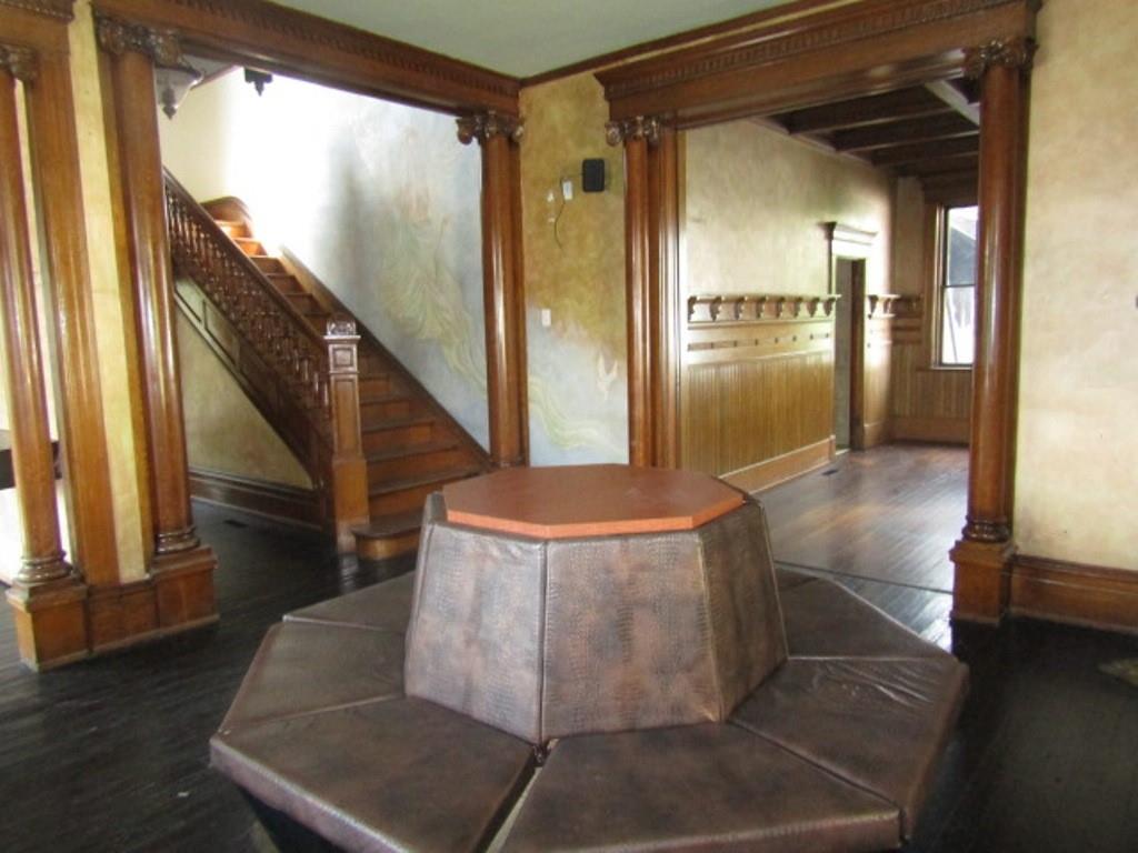 246 West Main Street Uniontown, PA 15401 - Photo 9 of 42 a view of a hallway with wooden floor and staircase