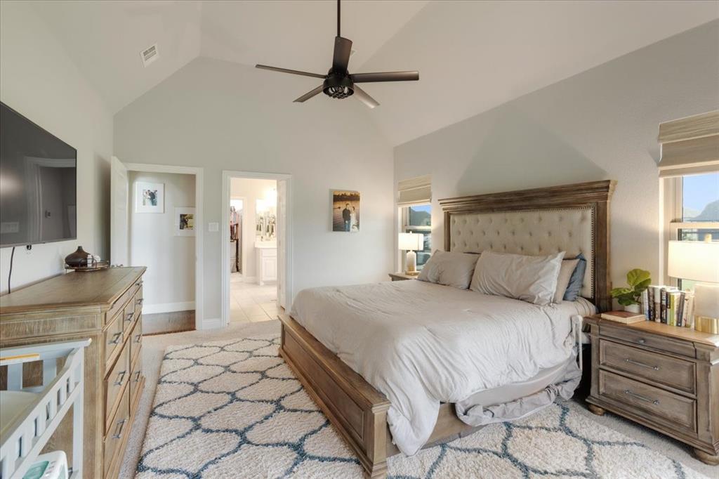 1205 Redbud Street Howe, TX 75459 - Photo 13 of 40 a bedroom with a bed a couch and a flat screen tv