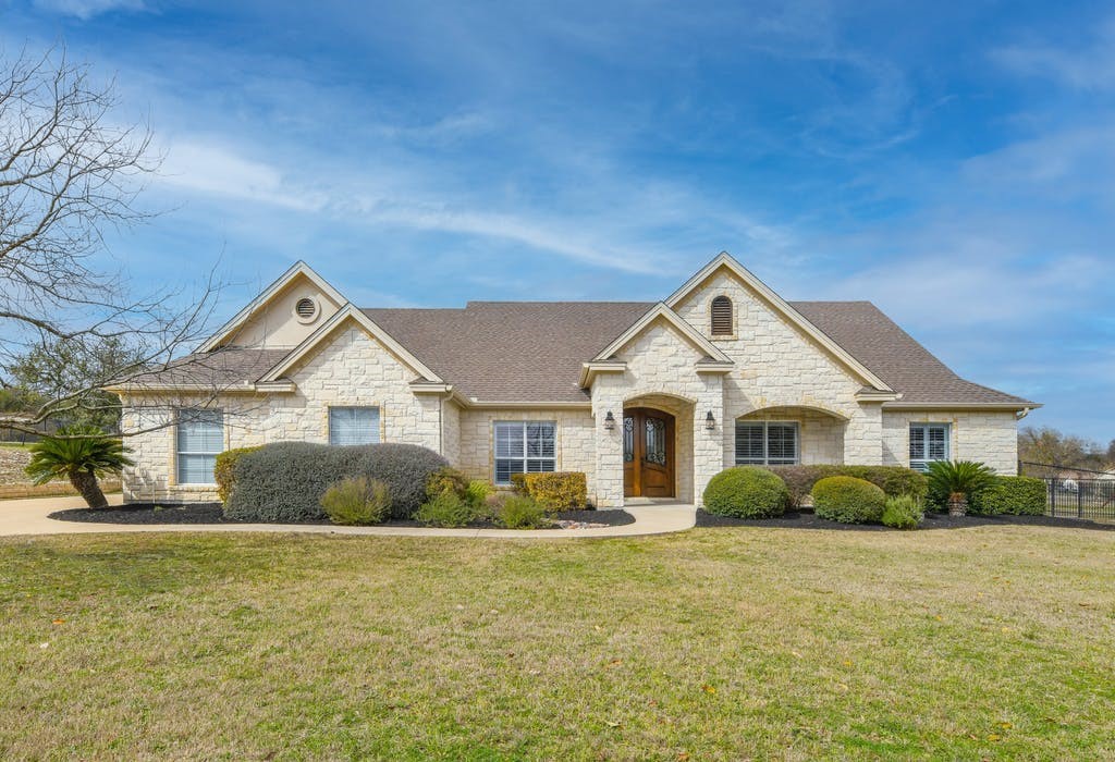a front view of a house with garden