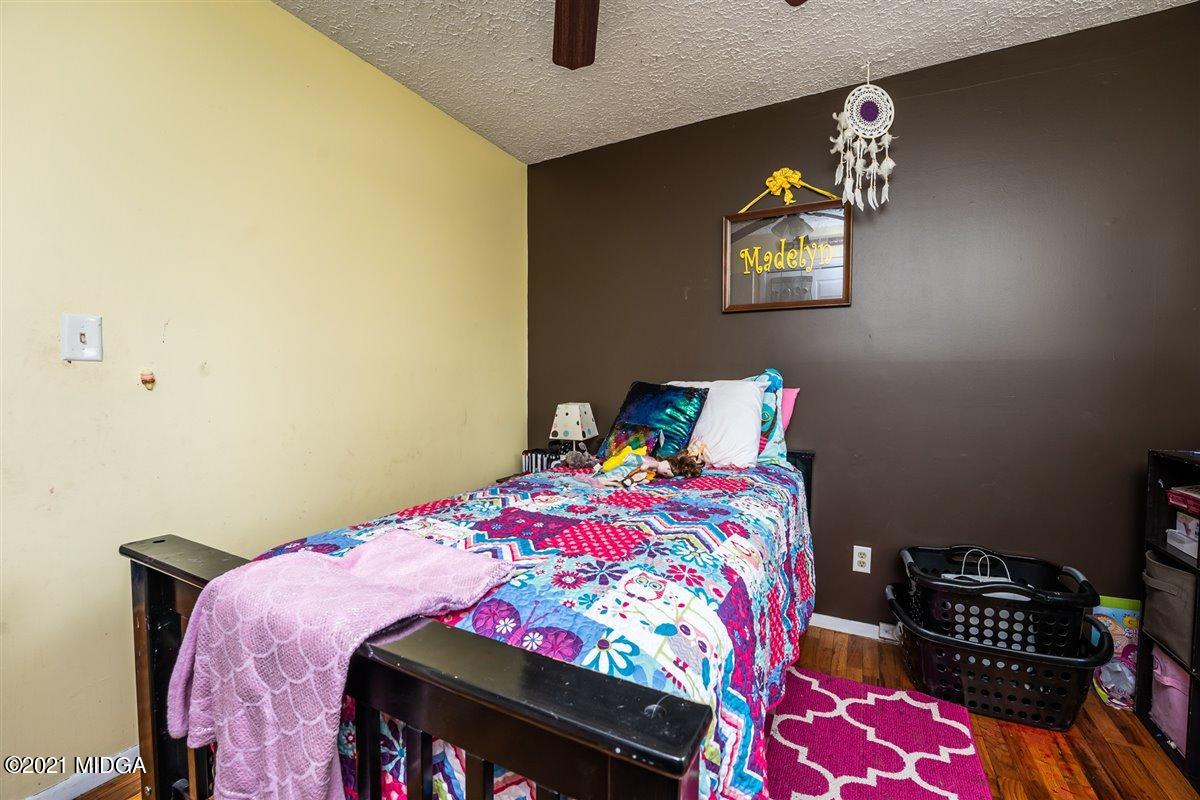 2805 South Estates Road Macon, GA 31216 - Photo 11 of 17 a bedroom with a bed a painting on the wall and a dresser